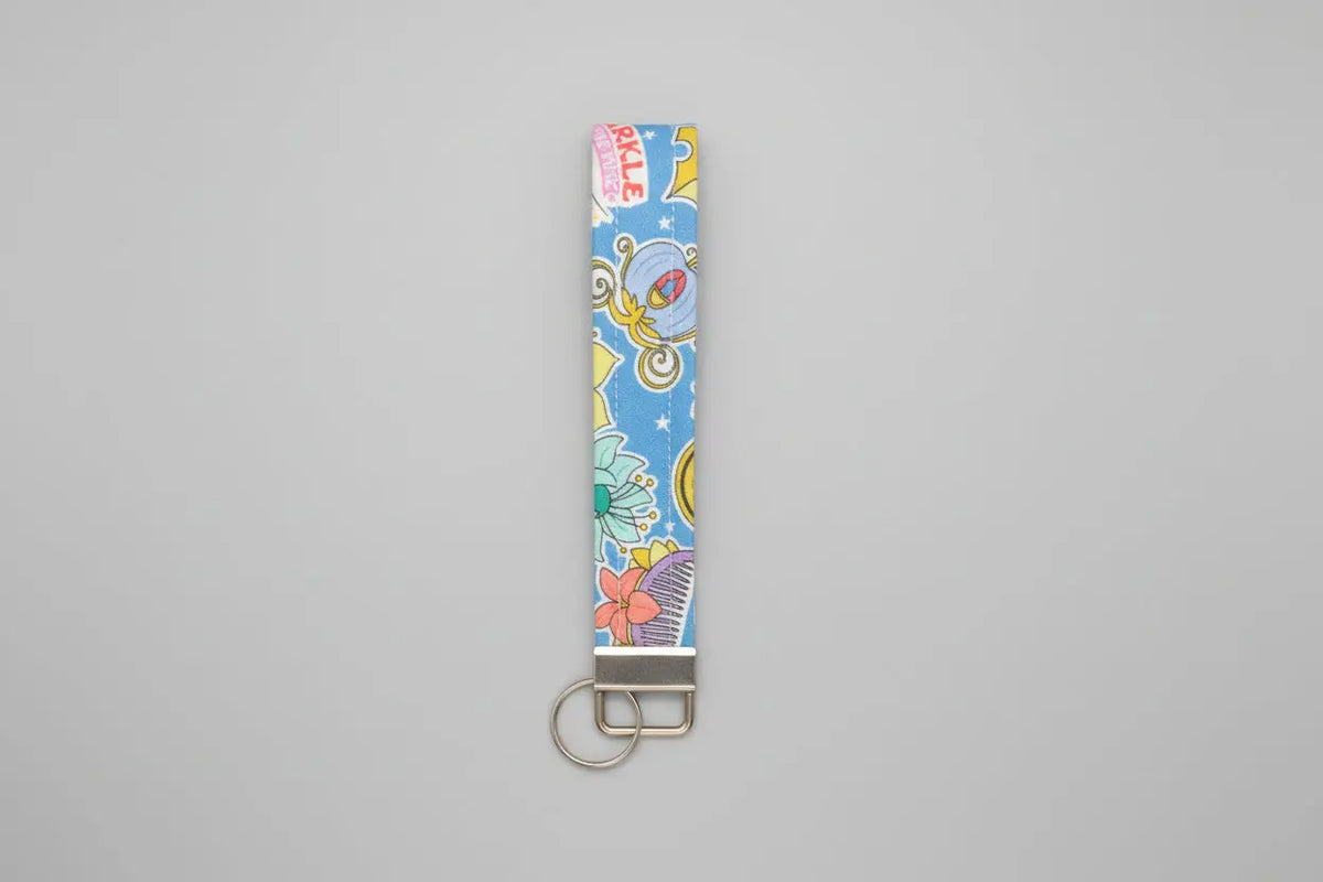 Colorful keychain with cartoon designs on a gray background