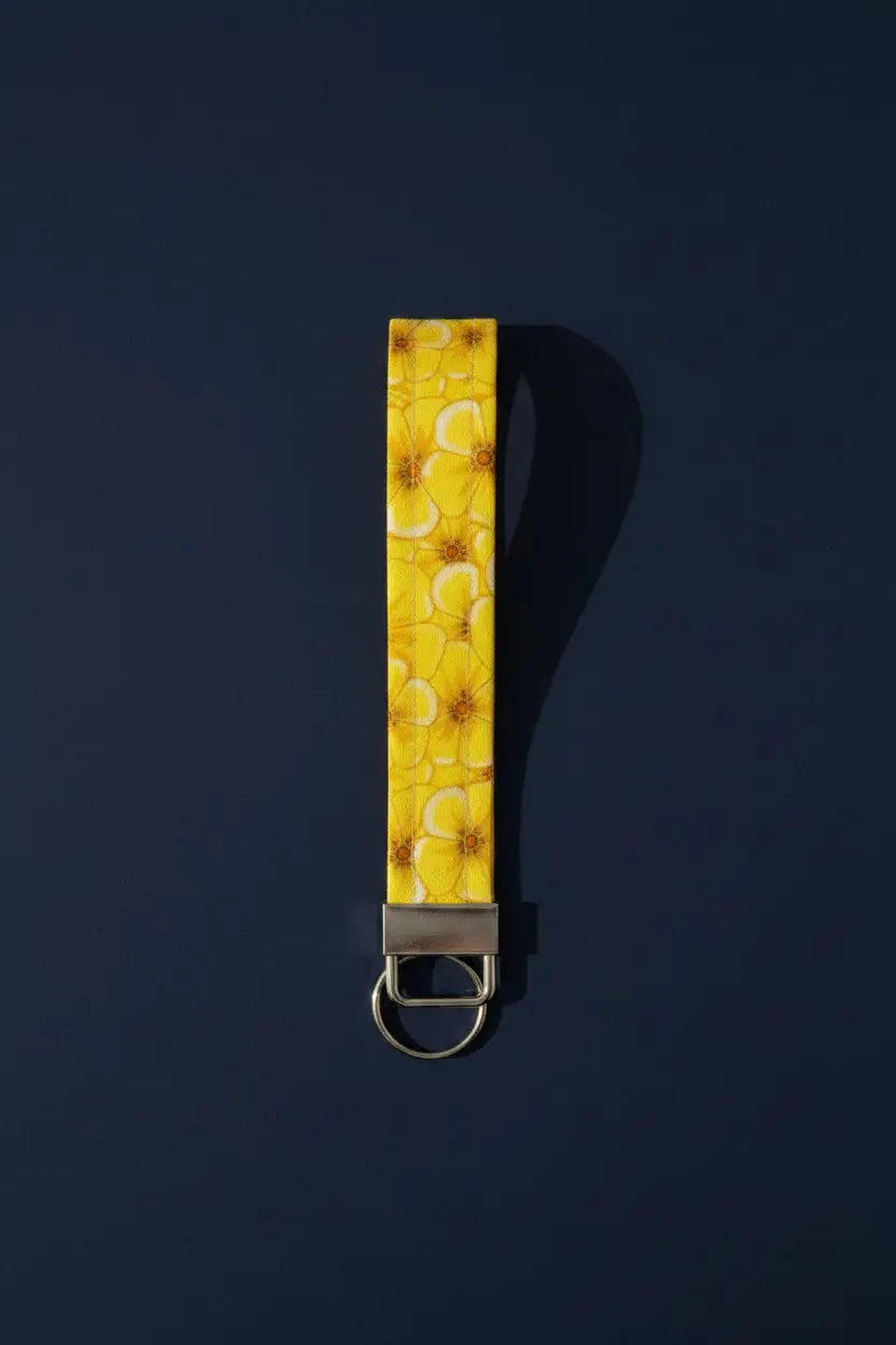Keychain with yellow floral pattern on a gray background