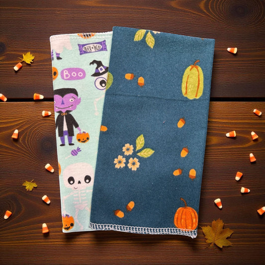 Crafts by Serenity reusable paper towels with festive Halloween pumpkin and ghost patterns on a wooden background.