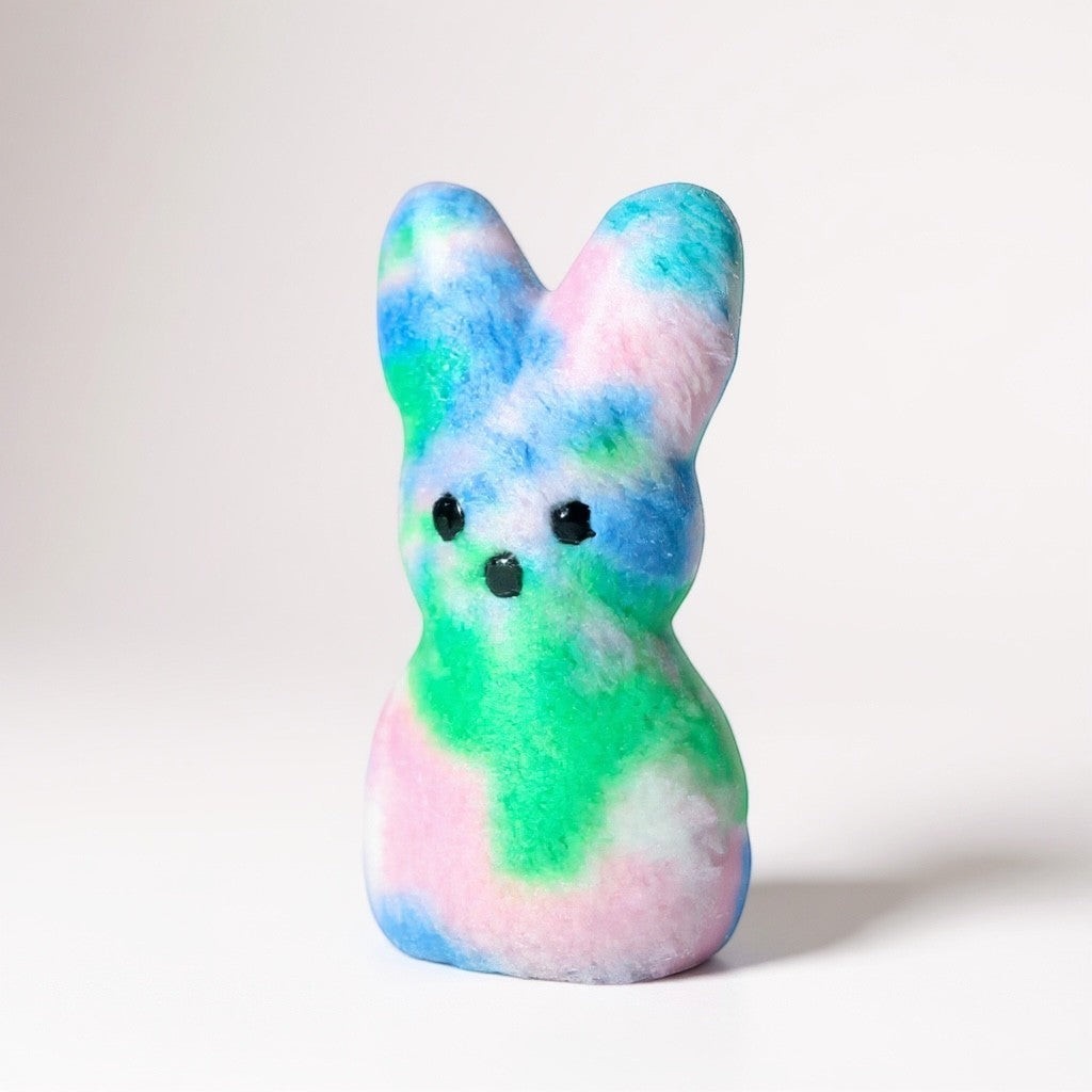 Crafts by Serenity personalized plush bunny keepsake with a vibrant multi-colored tie-dye pattern.