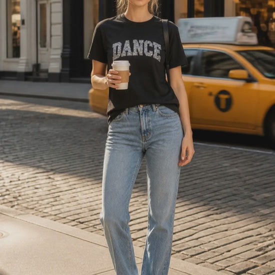 Black custom unisex t-shirt featuring a sparkling sequin and vinyl DANCE design across the front
